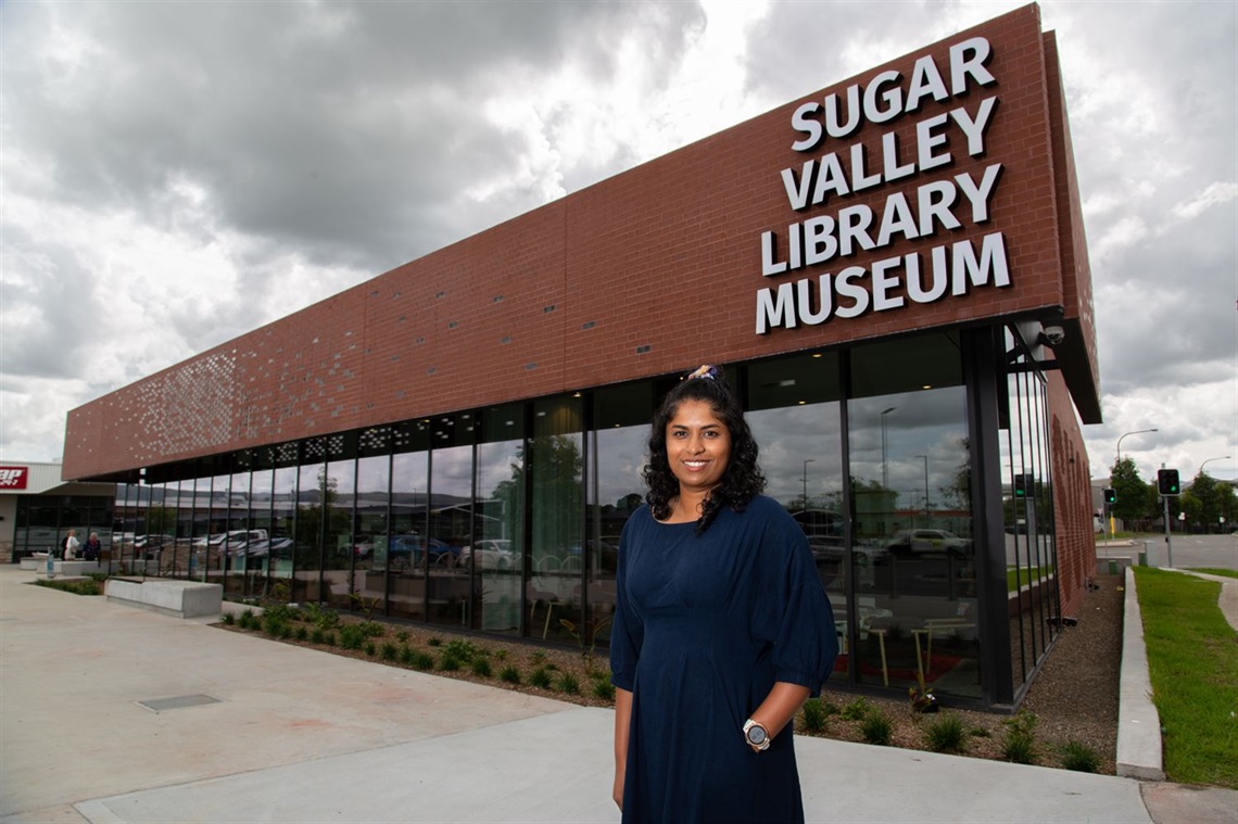 Sugar Valley Library Museum Leader Priya Mathew Johnson in front of the new facility at Cameron Park.jpg