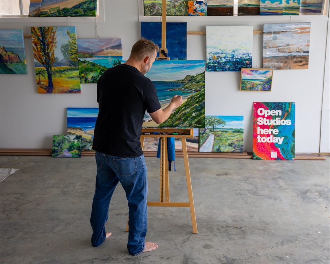 Denny Breese at work in his garage studio in Catherine Hill Bay.jpg