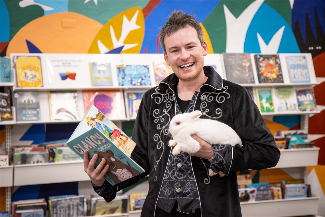 Joel Howlett and Carpenter the bunny reading Clancy the Quokka, at Charlestown Library.jpg