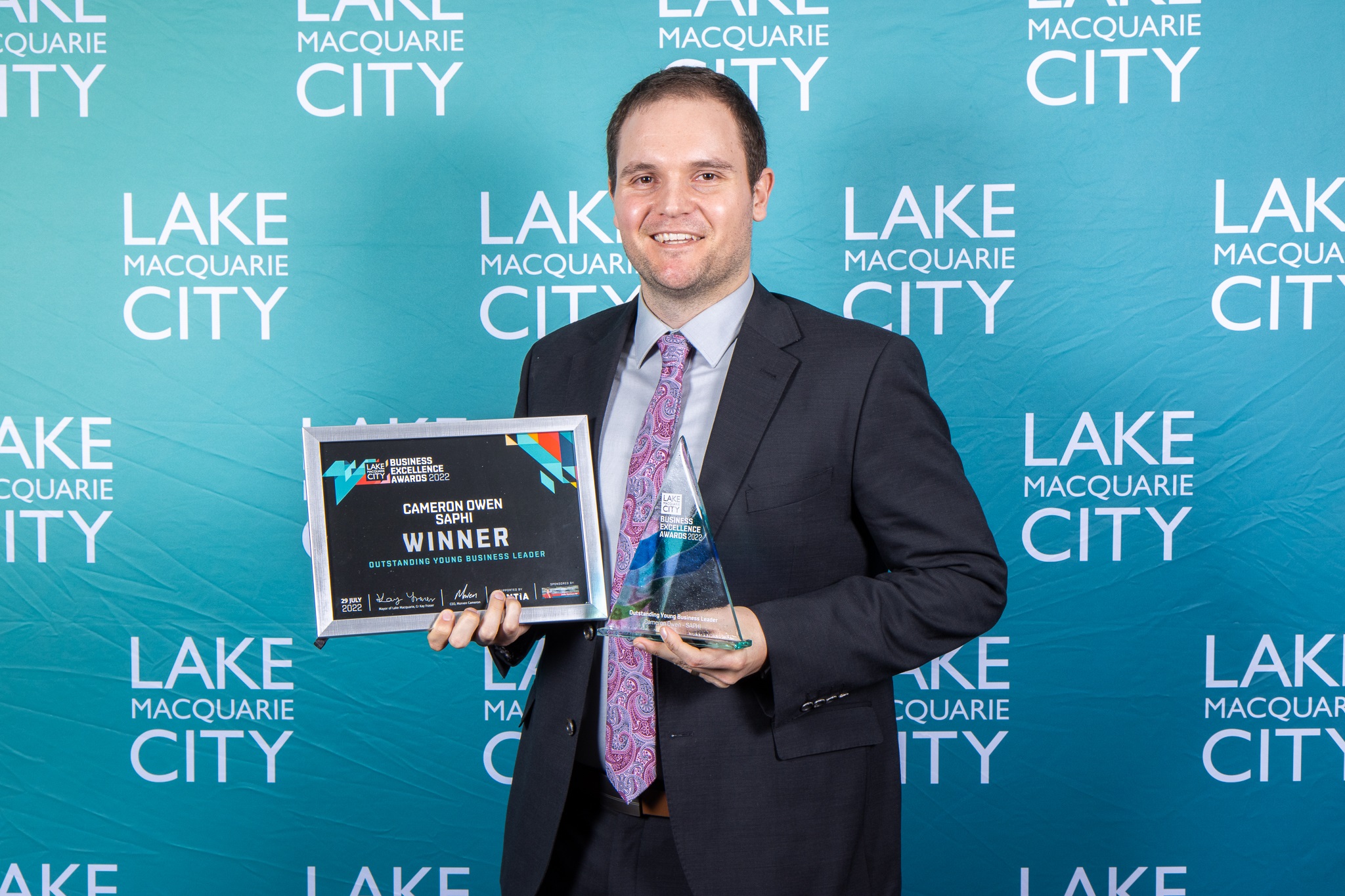 SAPHI Director Cameron Owen holds his 2022 Outsanding young business leader award.jpg