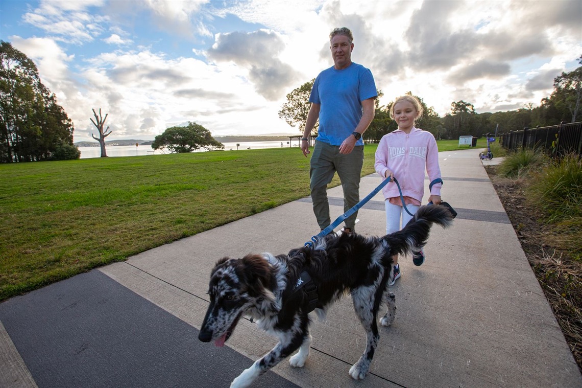 Scott Thompson with daughter Matilda, 7, and their border collie cross Hank at Thomas H Halton Park.jpg