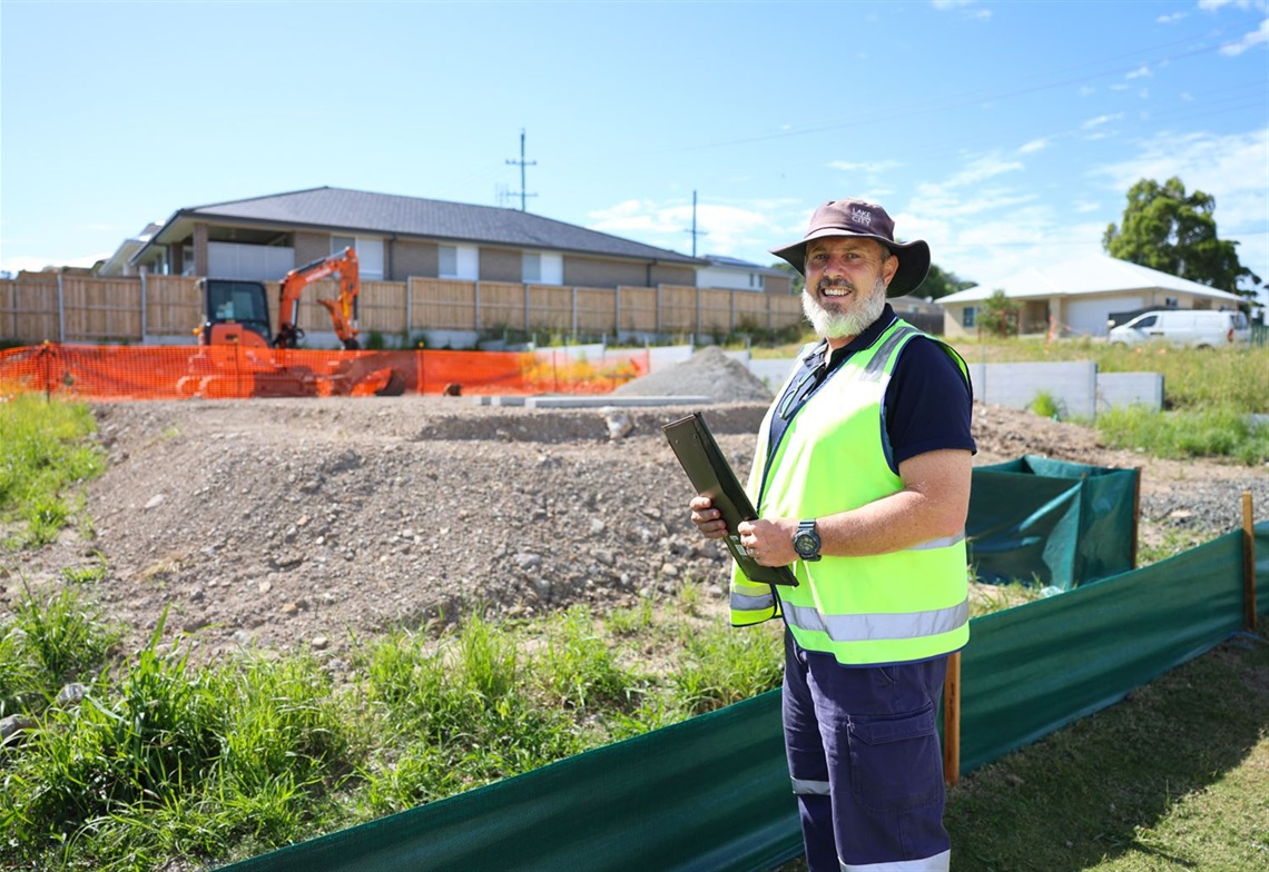 Lake Macquarie Compliance Officer Daniel Beck inspects a construction site.jpg