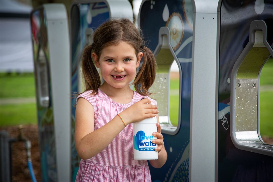 Cyan Meadberkel, 6, fills up at a mobile water station at Speers Point Park.jpg