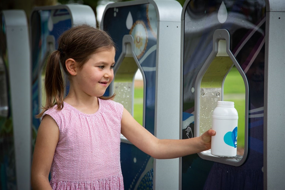 Cyan Meadberkel, 6, refills a bottle at a water station (1).jpg