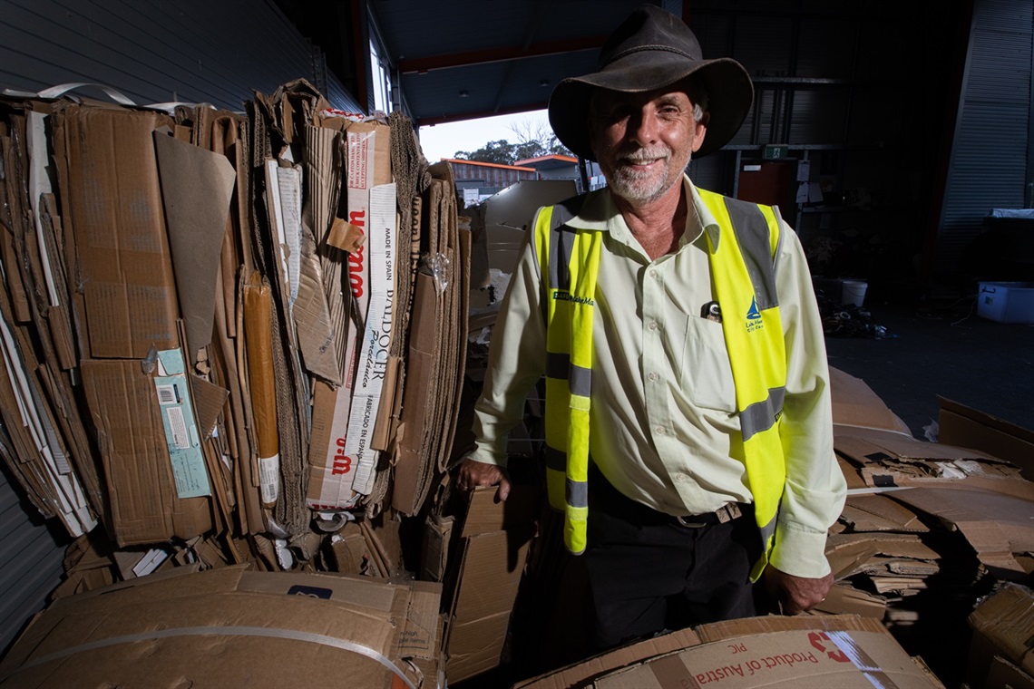 Awaba Waste Management Facility site coordinator Steve Merrett with stacks of cardboard inside the CRC.jpg