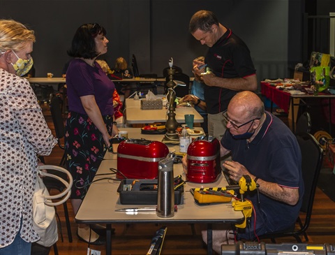 Skilled volunteers repair items at the Repair Cafe event in March 2022.jpg